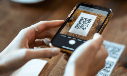 Customer scanning QR code on table to order